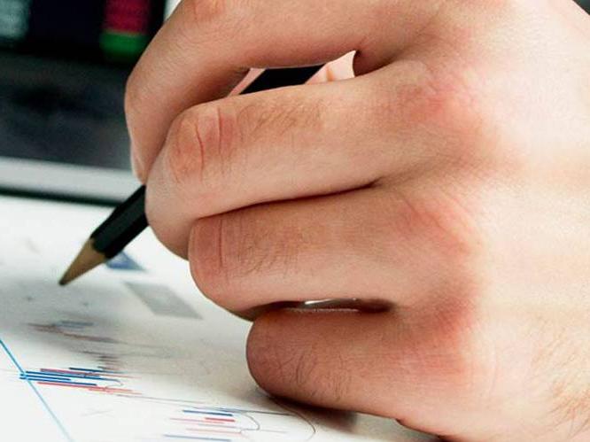 Student hovering over linegraph with pencil