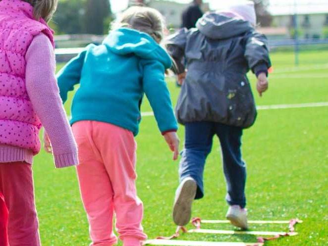 group of young children doing ladder exercises