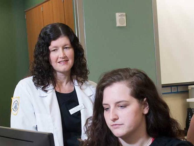 Teacher watching student focus on their computer