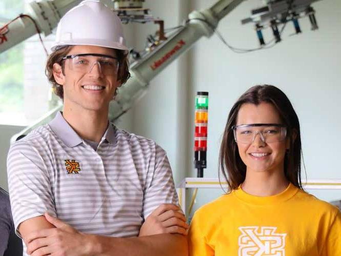 Man and woman wearing safety goggles smiling for a picture