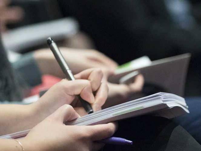 Student taking notes in their journal