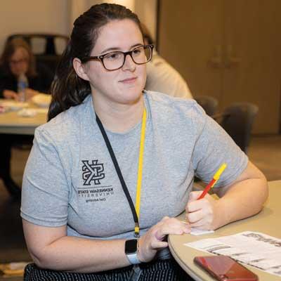 ksu student sitting at desk taking notes